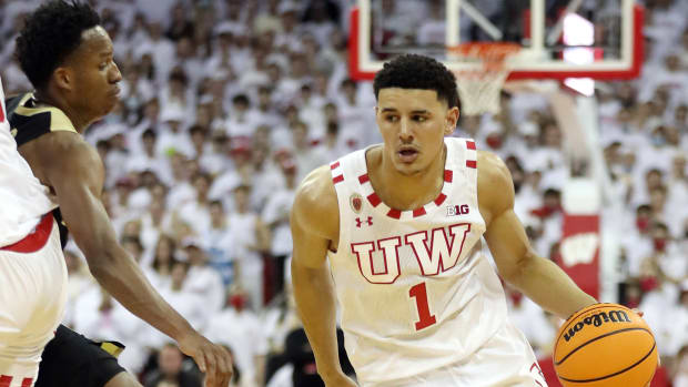 Wisconsin Badgers guard Johnny Davis (1) takes the ball past Purdue Boilermakers guard Eric Hunter Jr. (left) at the Kohl Center.
